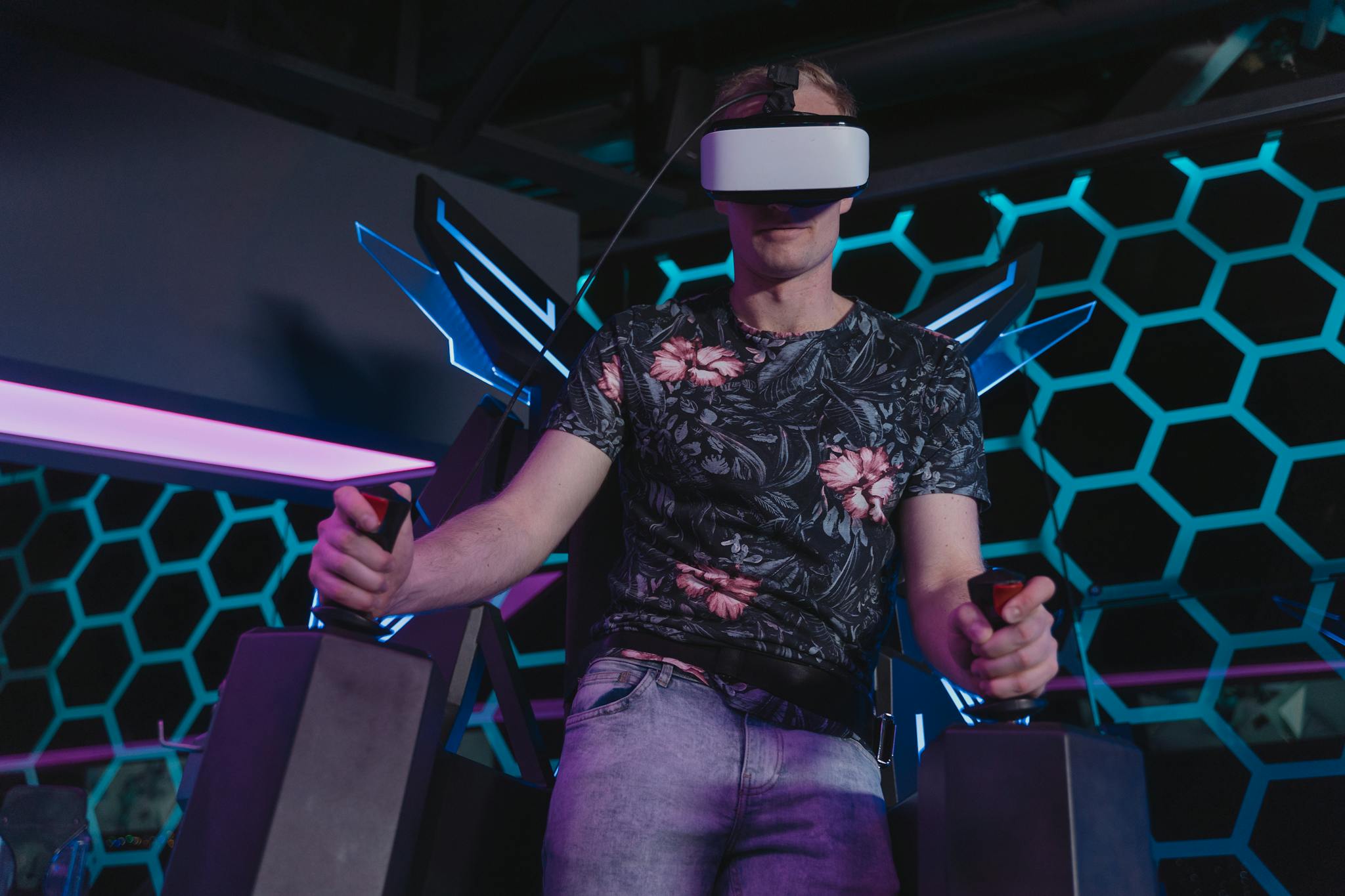 Man enjoying an immersive virtual reality gaming experience with VR headset and controllers.